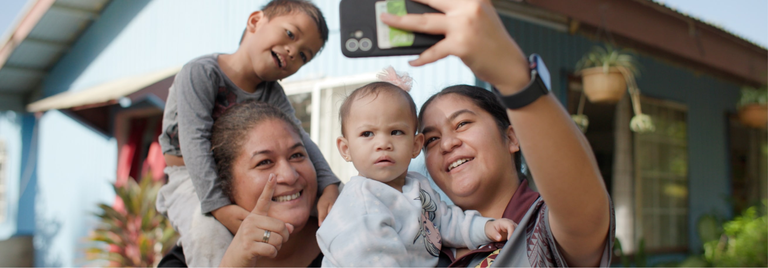 Photograph of mothers and children taking a selfie together